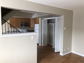 Prince Albert house for rent - an empty living room with a kitchen and a staircase