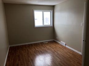 Prince Albert house for rent - an empty room with wooden floors and a window