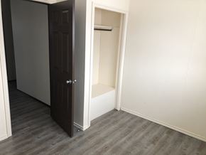 Prince Albert house for rent - a small closet in a room with wooden floors and a door