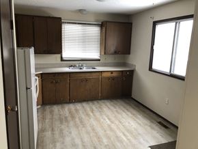 Prince Albert house for rent - an empty kitchen with wooden floors and wooden cabinets