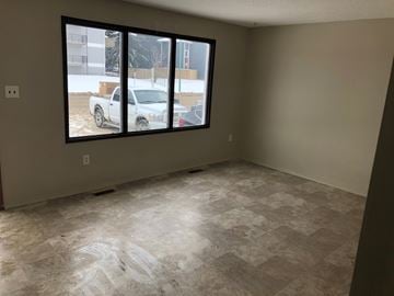Prince Albert house for rent - a living room with a large window and a tiled floor