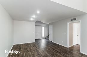Phoenix house for rent - a renovated living room with white walls and wood flooring