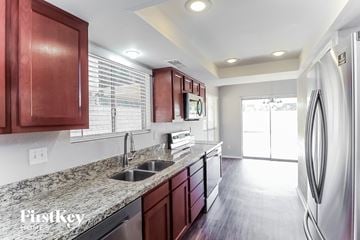 Phoenix house for rent - a kitchen with stainless steel appliances and granite counter tops