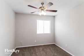 Phoenix house for rent - a bedroom with a ceiling fan and a window