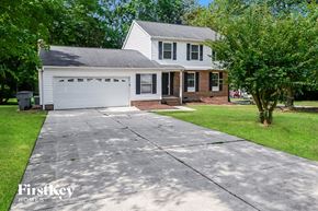 Charlotte house for rent - A house with a garage and a driveway in front of it.
