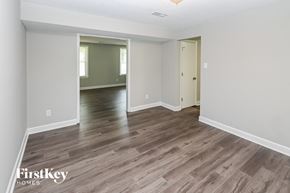 Charlotte house for rent - A room with wooden flooring and a mirror on the wall.