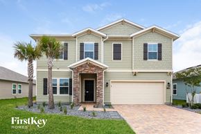 Jacksonville house for rent - a house with a garage door and a palm tree
