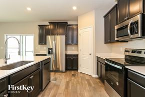 Jacksonville house for rent - a kitchen with black cabinets and stainless steel appliances