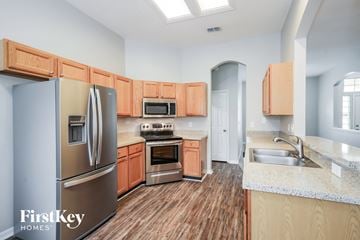Orange Park house for rent - A kitchen with wooden cabinets and a stainless steel refrigerator.