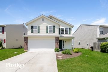 Loveland house for rent - a white house with green shutters and a driveway