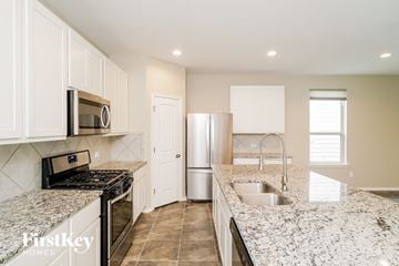 San Antonio house for rent - a kitchen with granite counter tops and stainless steel appliances