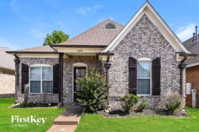 Memphis house for rent - a brick house with black shutters and a lawn