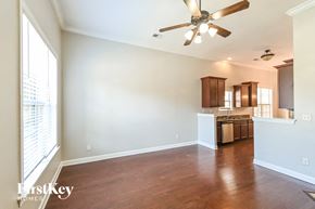 Memphis house for rent - an empty living room and kitchen with a ceiling fan