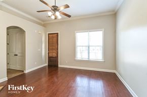Memphis house for rent - an empty living room with a ceiling fan and a window