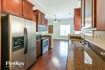 Memphis house for rent - a kitchen with stainless steel appliances and wooden cabinets