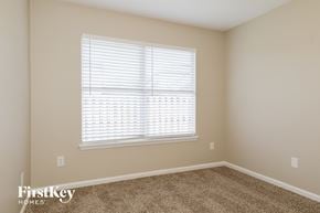 St Augustine house for rent - a bedroom with a large window and a carpeted floor
