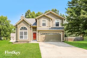 Shawnee house for rent - A house with a red door and a garage is shown.