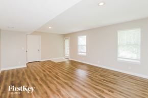 Shawnee house for rent - A spacious room with wooden flooring and white walls.