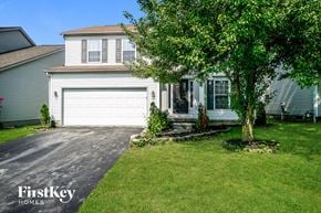 Columbus house for rent - a white house with a white garage door and a tree
