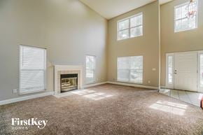 Columbus house for rent - an empty living room with a fireplace and windows
