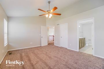 Columbus house for rent - a spacious living room with carpet and a ceiling fan