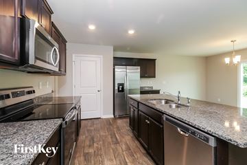 Dallas house for rent - A kitchen with a stainless steel dishwasher and a microwave above the stove.