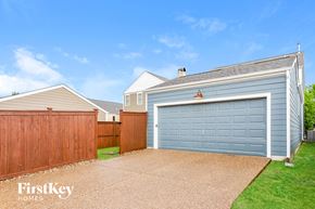 Saint Charles house for rent - a blue garage with a wooden fence and a blue house