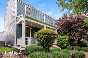 Saint Charles house for rent - a blue house with a porch and a garden