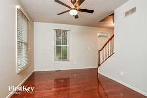 Saint Charles house for rent - a living room with hardwood floors and a ceiling fan