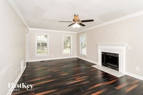 Greensboro house for rent - a living room with hard wood floors and a fireplace