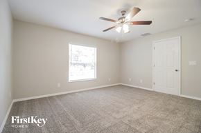 Cocoa house for rent - A spacious room with a ceiling fan and a window.