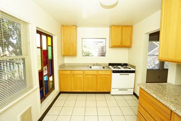 Berkeley apartment for rent - a kitchen with a stove and a sink and a window
