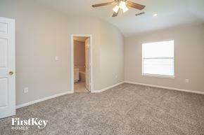 Baytown house for rent - the master bedroom with carpeted flooring and a ceiling fan