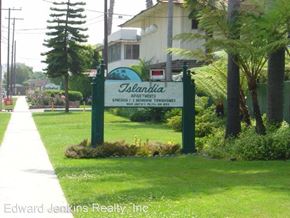Westminister apartment for rent - a sign in the grass in front of a house