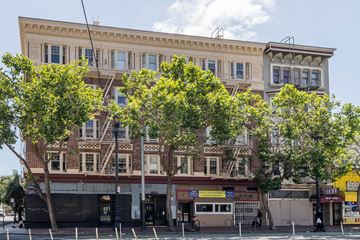 San Francisco apartment for rent - A large building with a yellow sign that says "Hotel" on the front.