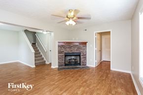 Jacksonville house for rent - A living room with a fireplace and a staircase.
