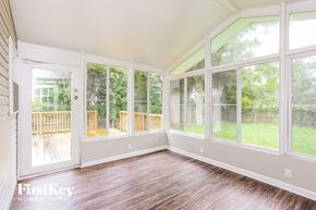 Jacksonville house for rent - A sunny room with a view of a deck and trees through the windows.