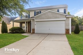 Charlotte house for rent - A two-story house with a garage is for sale.