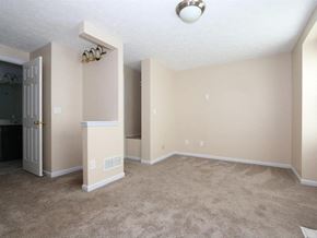 Maineville house for rent - A room with a carpeted floor and a fireplace.