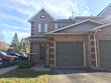 Guelph apartment for rent - a brick house with a garage and a driveway