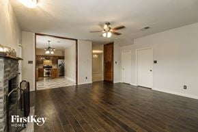 Little Elm house for rent - an empty living room with a fireplace and a ceiling fan