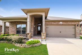 Fort Worth house for rent - A house with a garage and a driveway in front of it.
