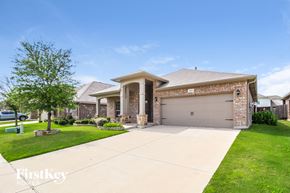 Fort Worth house for rent - A house with a garage and a driveway in front of it.