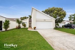 Melbourne house for rent - a white house with a driveway and a lawn