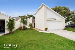 Melbourne house for rent - a white house with a lawn and a driveway