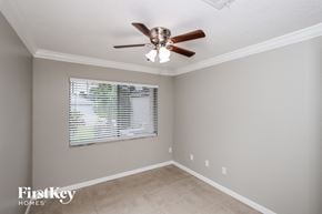 Melbourne house for rent - a bedroom with a ceiling fan and a window