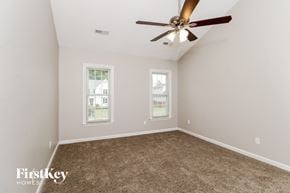 High Point house for rent - a bedroom with carpet and a ceiling fan
