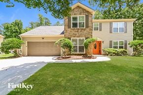 Lithonia house for rent - A house with a brown door and a garage.