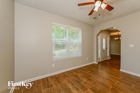 Lithonia house for rent - A room with wooden floors and a ceiling fan.