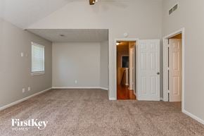 Lithonia house for rent - A spacious room with a carpeted floor and a ceiling fan.